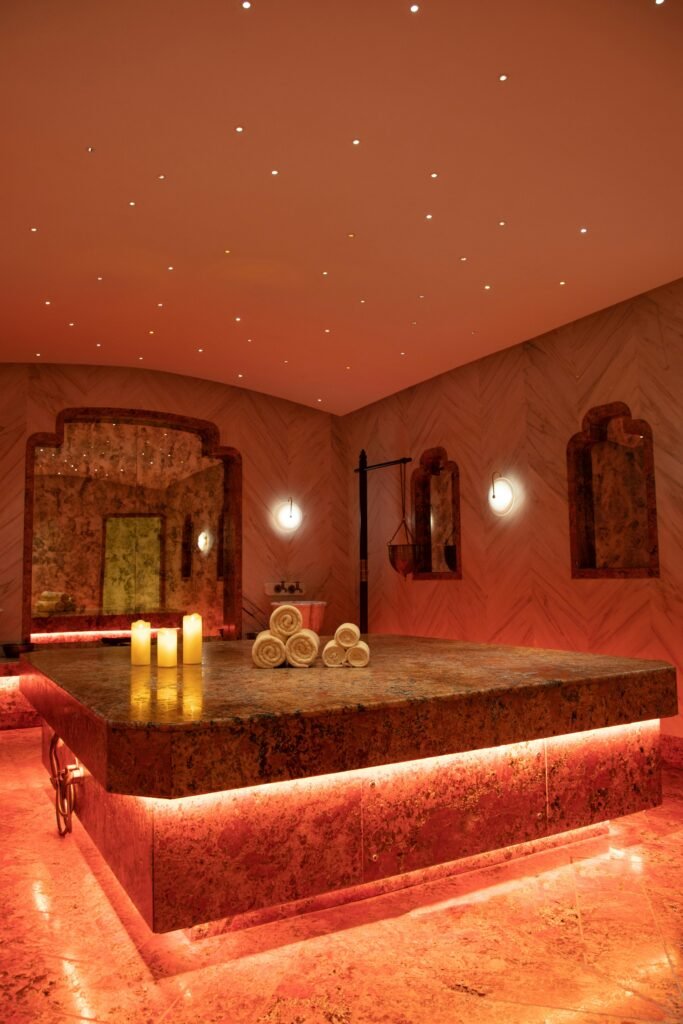 pexels-photo-33852650-33852650 Exquisite Turkish bath in Delhi with warm lighting, towels, and candles.